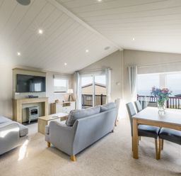 A living room with a sofa and dining table at Lodge 73 at Riviera Bay Coastal Retreat Brixham