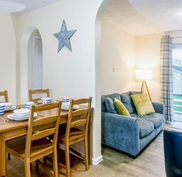 A dining area with table and chairs at Chalet 31 at Landscove Holiday Park Brixham