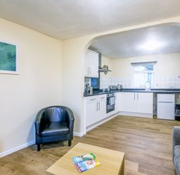 A kitchen area with a sink and stove at Chalet 31 at Landscove Holiday Park Brixham