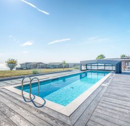 An outdoor area with a swimming pool and seating at Chalet 15 at Landscove Holiday Park Brixham