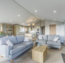 A living room with sofas and a coffee table at Lodge 15 at Landscove Holiday Park Brixham