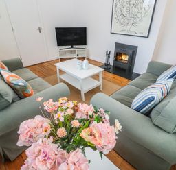 A living room with a fireplace and a TV at Bod A Quinte in Carbis Bay