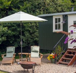 An outdoor area with deck chairs and an umbrella at Collen Aberaeron