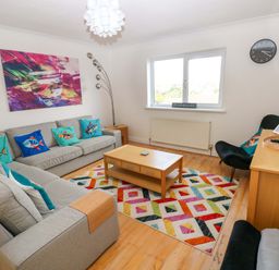 A living room with a couch and coffee table at 15 Lawnswood in Saundersfoot
