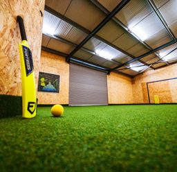 A sports training facility with a cricket bat, ball, and goal posts at Glanllyn Bach, Llanfaelog