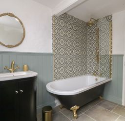 A bathroom with a bathtub, sink, and shower at Tan Y Merddyn in Ceunant near Llanrug