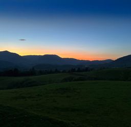 A landscape with hills and grass under a sunset sky at Ty Dyffryn in Llan Ffestiniog