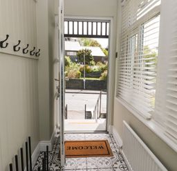 A hallway with hooks and a welcome mat at 5 Thornbarrow Road in 