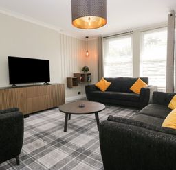 A living room with a television and a coffee table at 5 Thornbarrow Road