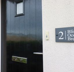 A front door with a sign at Blissful Ocean Breeze in Perranporth