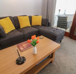 A living room with a sofa and a coffee table at Lake View, Swanpool, Nr Falmouth