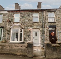 Stone facade terrace houses with bay windows and front gates at 1 Mona Terrace in Llanfachraeth