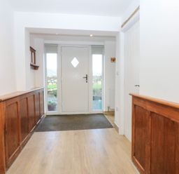 A hallway with a door and wooden panelling at Yr Hen Felin Dyffryn Ardudwy