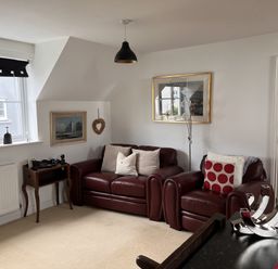 A living room with a sofa and chair at 20 Keay Heights St Austell