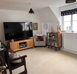 A living room with a television and a display shelf at 20 Keay Heights St Austell