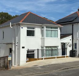 A house with a driveway and a fence at The Swanage Rail Lookout in Swanage