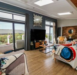 A living room with a television and coffee table at Coogee View near Maenygroes near New Quay
