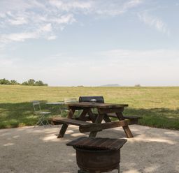 A picnic table and chairs in an outdoor area at Hollie in Raglan