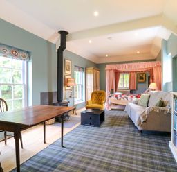 A living room with a table and chairs at Clock Tower in Stowmarket