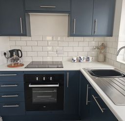 A kitchen with stove and sink at Seahorses in Kinmel Bay