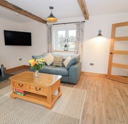 A living room with a sofa and coffee table at Y Stabl in Cerrigydrudion