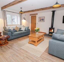 A living room with a sofa and a coffee table at Y Stabl in Cerrigydrudion