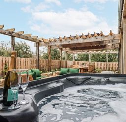 An outdoor area with a hot tub and seating at Lower Moorwood Moorwood near Bovey Tracey