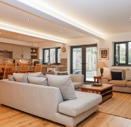 A living room with a kitchen area at Lower Moorwood in Moorwood near Bovey Tracey
