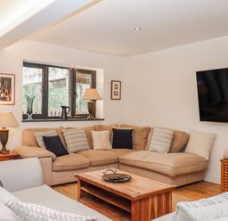 A living room with a sofa and coffee table at Lower Moorwood in Moorwood near Bovey Tracey