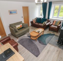 A living room with sofas and a coffee table at Folly Cottage Llanteg near Saundersfoot