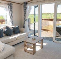 A living room with a sofa and coffee table at Magnolia Lodge in Whitby