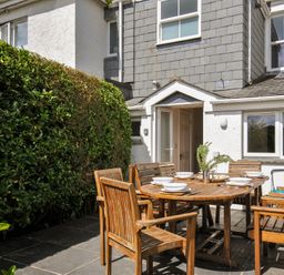 An outdoor patio with a dining table and chairs at 2 Glyddins 1910 in Rock