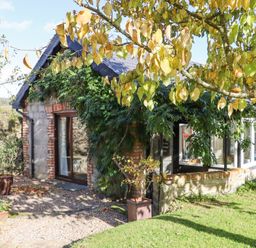 A stone and brick garden room with climbing plants and trees near Tinahely County Wicklow