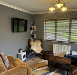 A snug with a television and seating at 22 Two Little Ducks in Lynton