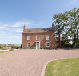 A house with a driveway and trees at Daniels Farmhouse in Claines