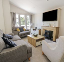A living room with couches coffee table fireplace and wall mounted TV at Bethany's Retreat in Wemyss Bay