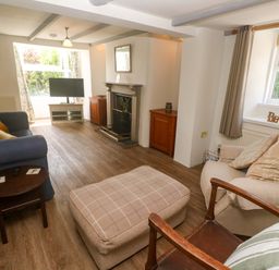 A living room with a sofa and coffee table at Greenways in Perranporth