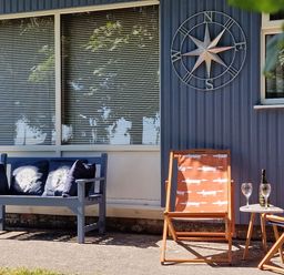 An outdoor seating area with a sofa and chairs at Driftwood in Dartmouth