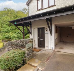 An entrance with a door and garage at Waterfall in Ambleside