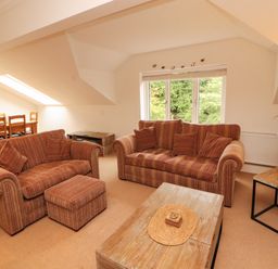 A living room with sofas and a coffee table at Waterfall in Ambleside