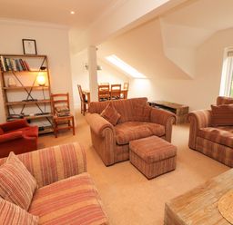 A living room with seating arrangements and a dining area at Waterfall in Ambleside