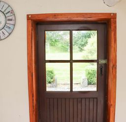 An entryway with a door and clock at Orchard Barn Wexford