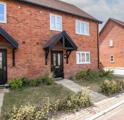 A front view of a house with pathways and gardens at Inishnee House Shotley Gate