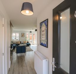 A hallway with a door and a view into a living area at Inishnee House in Shotley Gate
