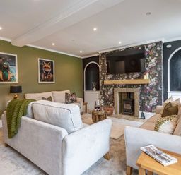 A living room with a sofa and television at Snowdonia Manor in Dolgellau