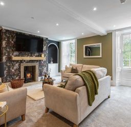 A living room with a fireplace and a television at Snowdonia Manor in Dolgellau