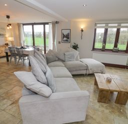 A living room with a sofa and coffee table at Little Acre in Church Lench near Harvington