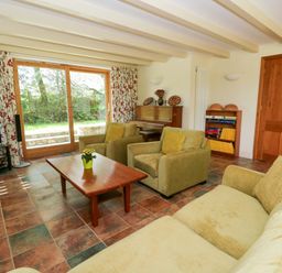 A living room with furniture including a sofa and television at Bryn Isaf in Swyddffynnon near Pontrhydfendigaid