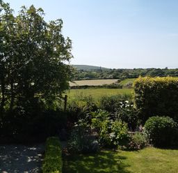 A garden with trees and bushes at Higher Merther Farm Shepherds Hut Sithney near Helston