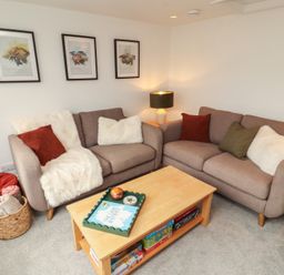 A living room with sofas and a coffee table at Rothay Cottage in Ambleside